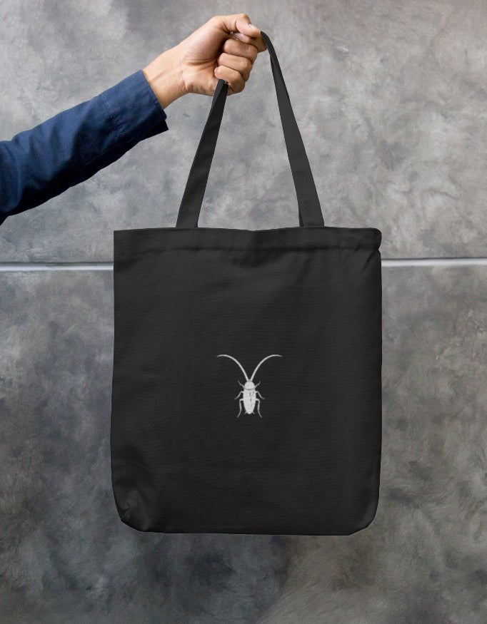 Back Premium black cotton canvas zip tote bag by Roach Resistance featuring long double-stitched handles.