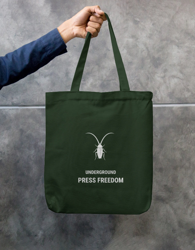 Front Eco-friendly bottle green canvas tote bag with a secure zipper closure by Roach Resistance.