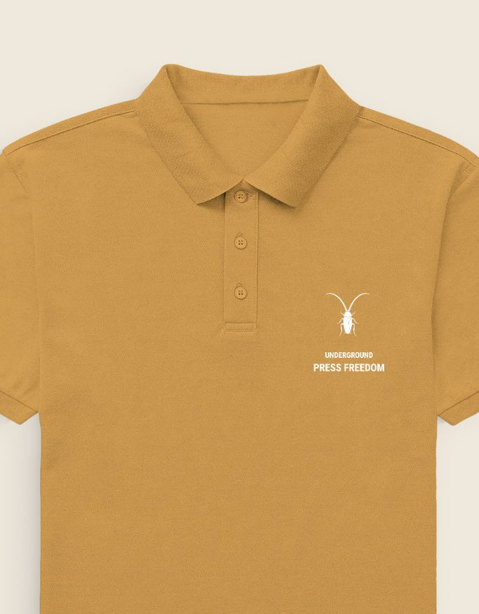 Left Elevated mustard yellow unisex regular fit polo shirt in premium 220GSM cotton from the Roach Resistance Press Freedom capsule.
