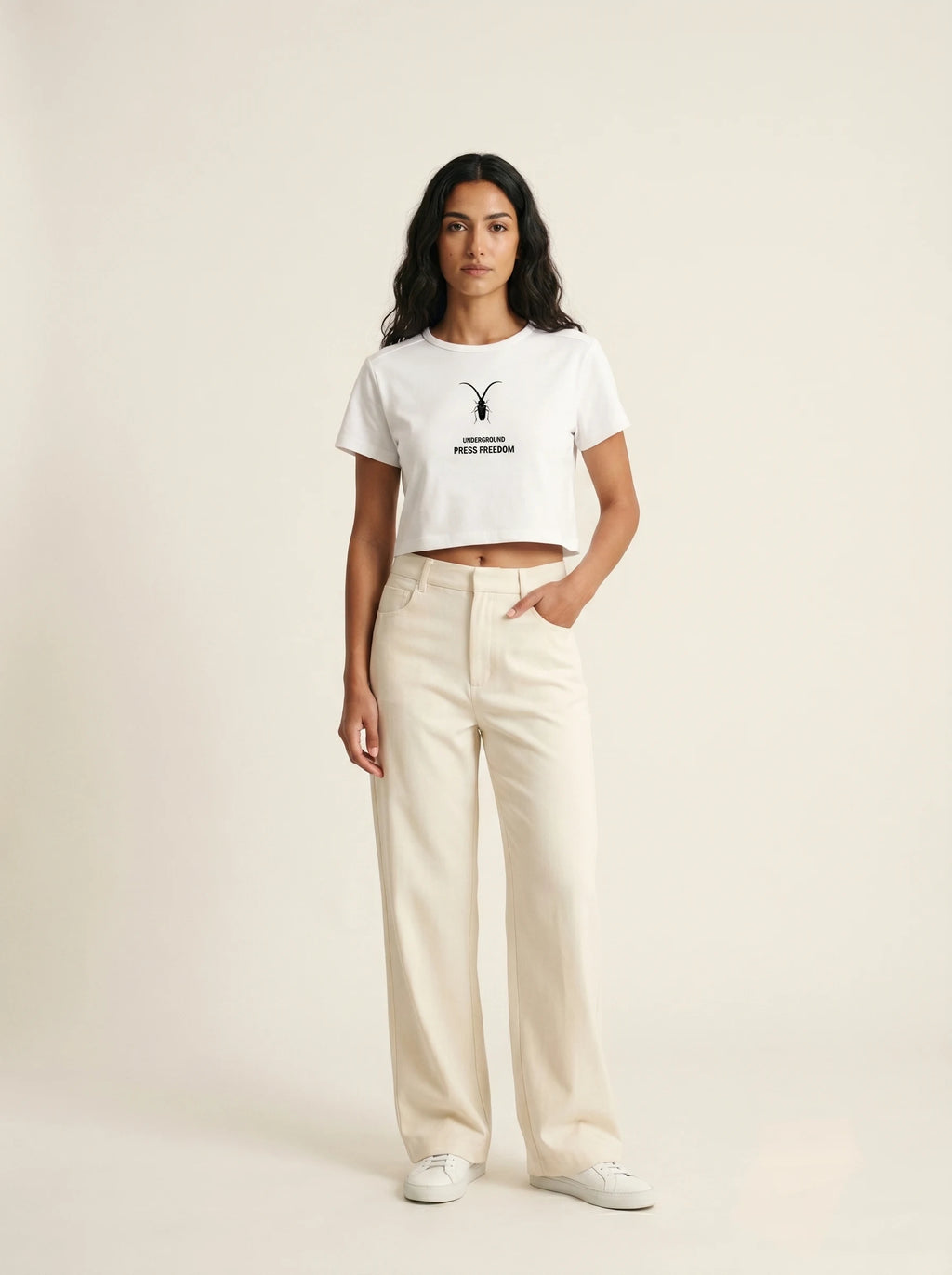 Front view of the Roach Resistance Press Freedom white baby tee for women, showcasing the fitted cropped silhouette.