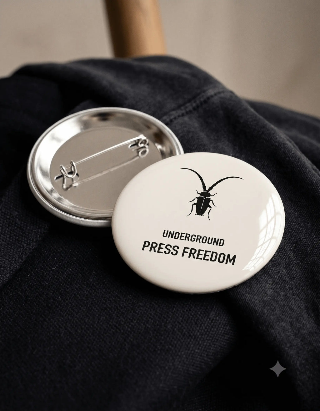 Close-up of the secure pin-back fastening on the Roach Resistance rust-free metal badge.
