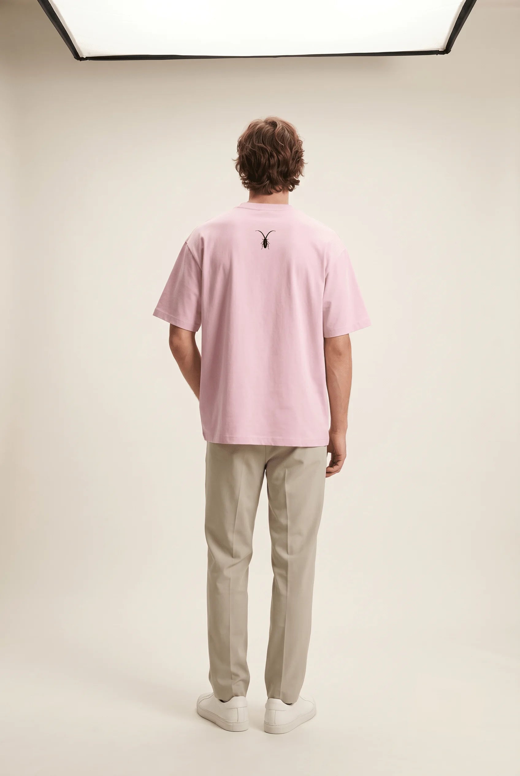 Back Image Alt Text: Back view of the premium stretch baby pink unisex tee from the Roach Resistance Press Freedom drop.