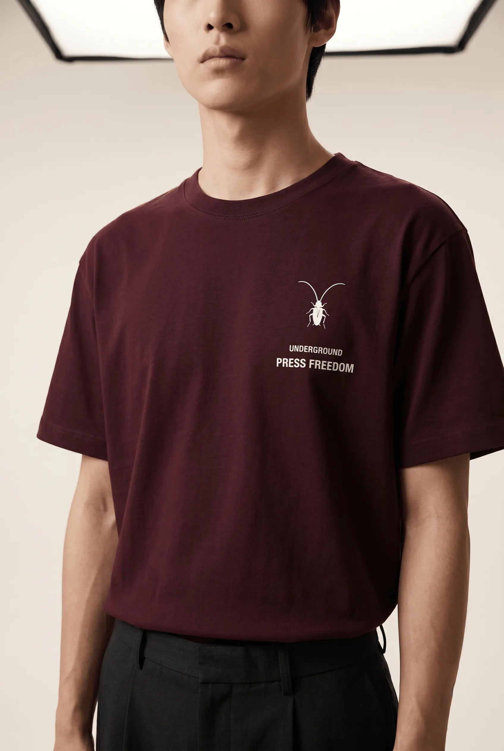 A details minimalist regular fit unisex maroon t-shirt by Roach Resistance from the Press Freedom drop, featuring luxury Supima cotton.