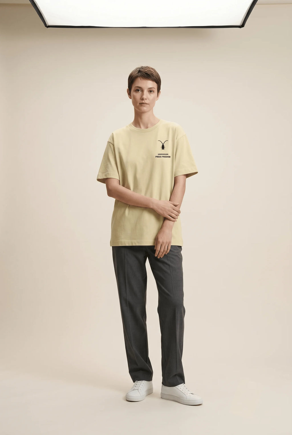 Female fashion model styling a premium stretch tee from the Roach Resistance Press Freedom streetwear collection.