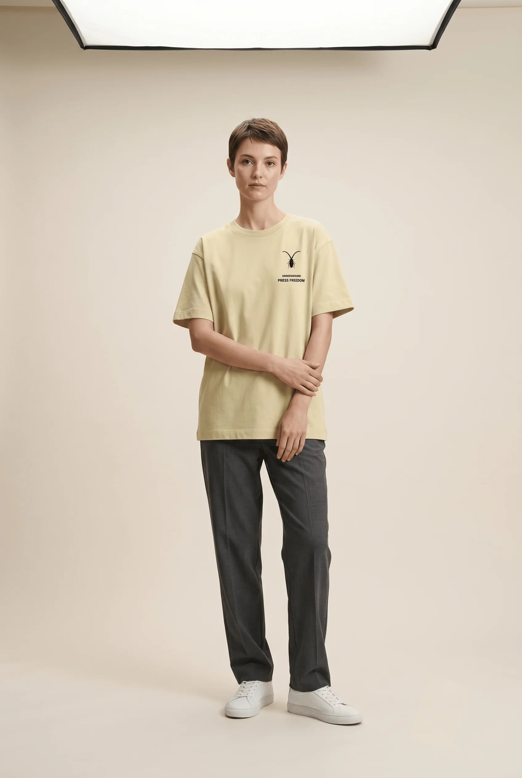 Female fashion model styling a premium stretch tee from the Roach Resistance Press Freedom streetwear collection.